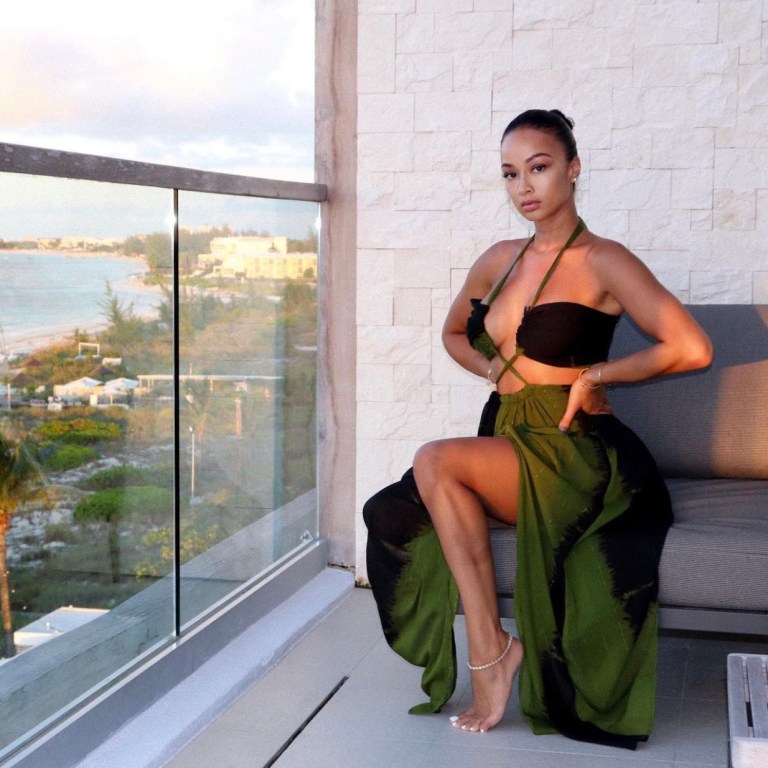 Draya Michele Delivers Vacay Style Moment Wearing Fashion Nova Olive Green Cutout Halter Maxi Dress