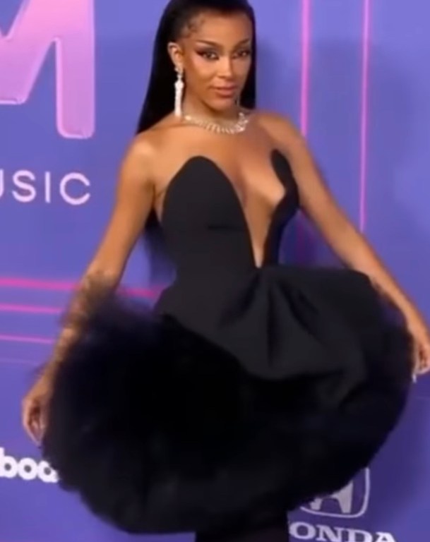 Doja Cat Attends The Billboard Women in Music 2022 event in a Black Carolina Herrera FW 22 Dress