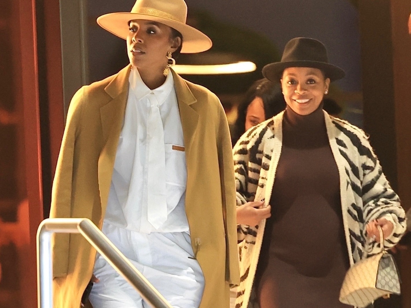 Kelly Rowland Grabbed Dinner with Bresha Webb Wearing a Camel YSL Coat, a White Patton Studio Short Set and a Lack of Color Hat