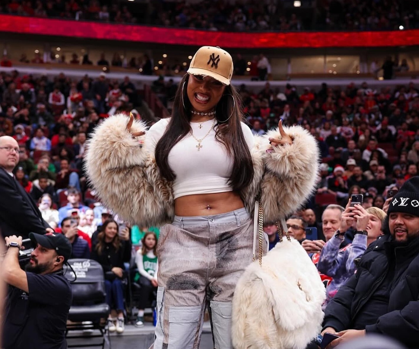 Megan Thee Stallion Attends the Bulls vs Celtics Game in a DSquared Fur Coat, Who Decides War Cargo Pants, and a YSL Niki Oversized Fur Bag