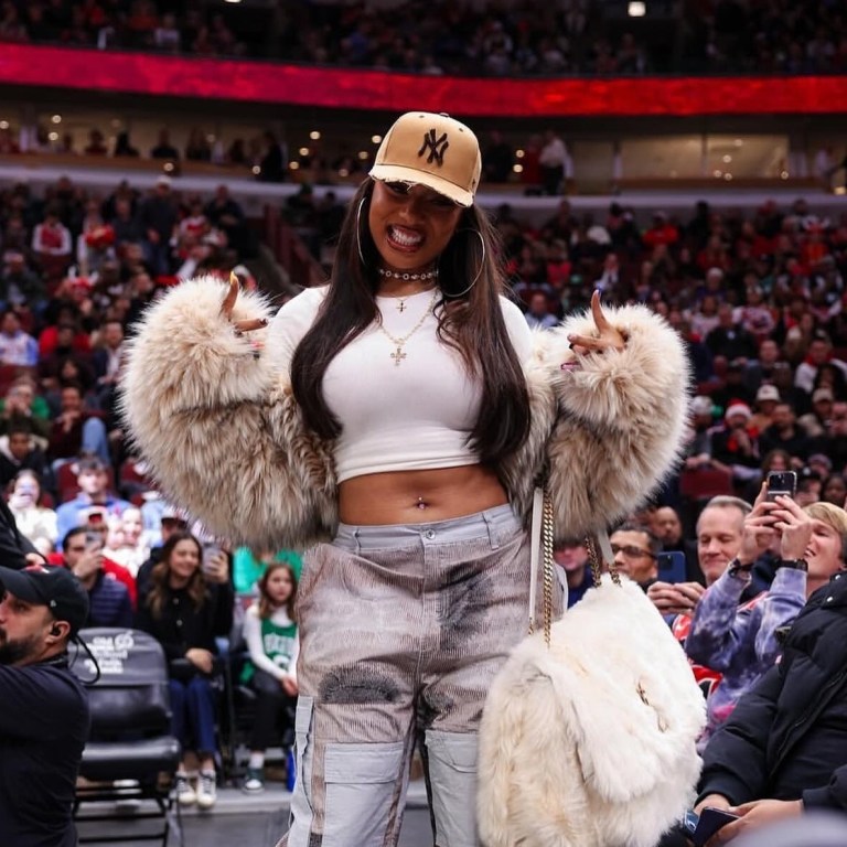 Megan Thee Stallion Attends the Bulls vs Celtics Game in a DSquared Fur Coat, Who Decides War Cargo Pants, and a YSL Niki Oversized Fur Bag