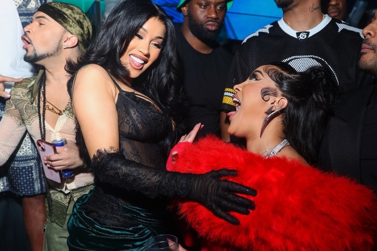 Cardi B Celebrates the New Year in Miami Wearing a Mimoza Kadriaj Black Velvet Drape Gown and a Custom Jordon Wllis Pink and Green Lace Mini Dress