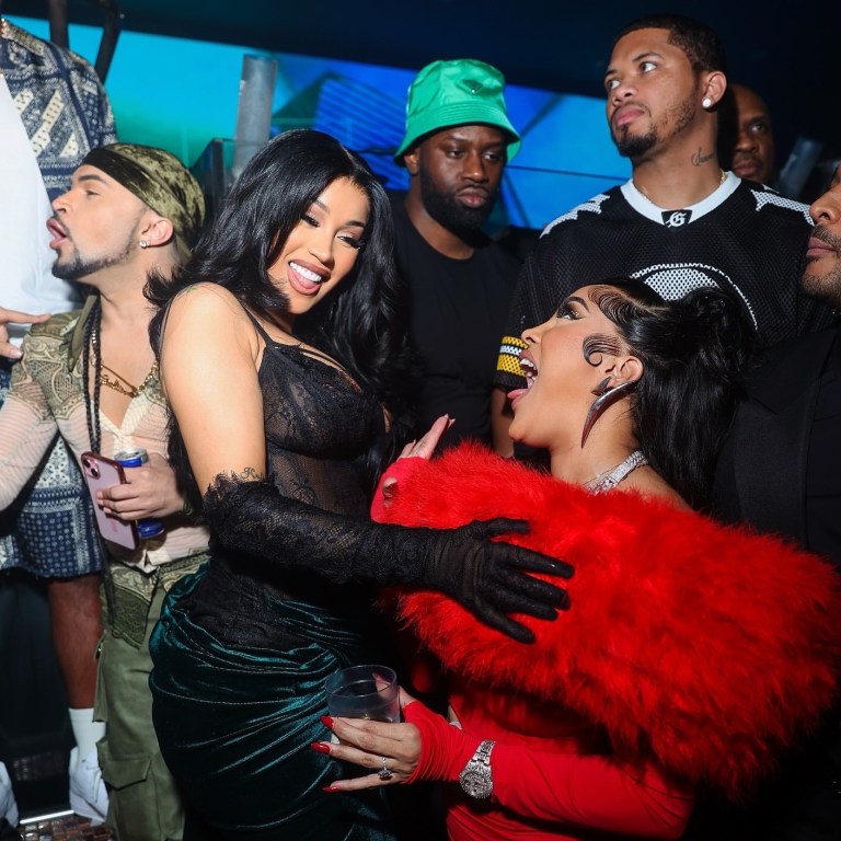 Cardi B Celebrates the New Year in Miami Wearing a Mimoza Kadriaj Black Velvet Drape Gown and a Custom Jordon Wllis Pink and Green Lace Mini Dress