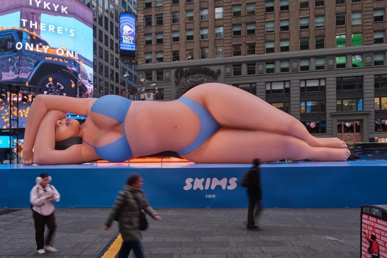 Kim Kardashian Promotes Skims Swim with a Blue Bikini Clad Blow Up Doll in Times Square