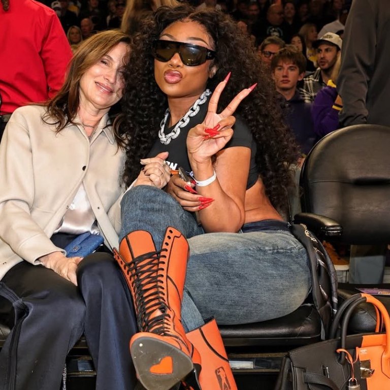 Megan Thee Stallion Courtside in Orange Lace-Up Heels and a Black-and-Feu Hermès Casaque HAC Bag at the Mavs vs. Lakers Game
