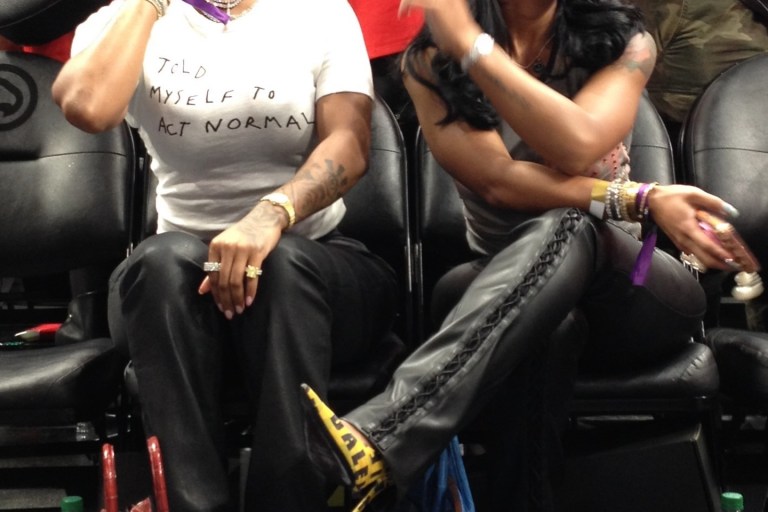 Dess Dior in Vintage Giuseppe Zanotti Shell Heels and Jayda Cheaves in Balenciaga Caution Tape Pumps at an Atlanta Dream WNBA Game