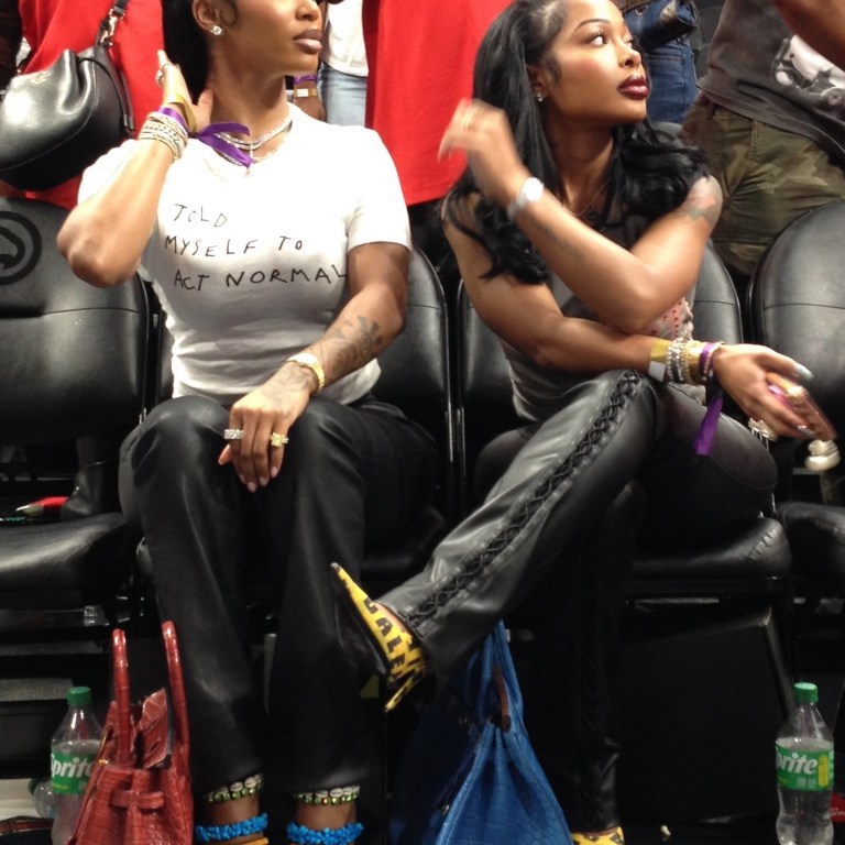 Dess Dior in Vintage Giuseppe Zanotti Shell Heels and Jayda Cheaves in Balenciaga Caution Tape Pumps at an Atlanta Dream WNBA Game