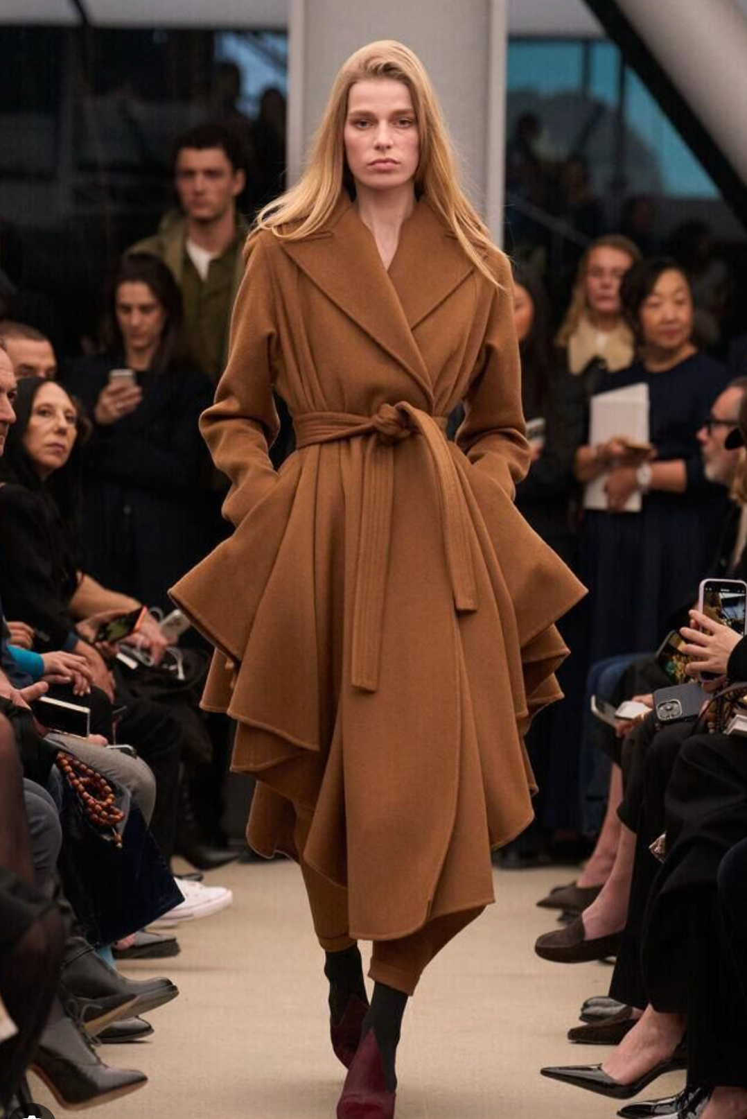 Celine Dion Wore An Asymmetric Caramel Alaia Trench Coat And Cutout Suede Boots In Paris